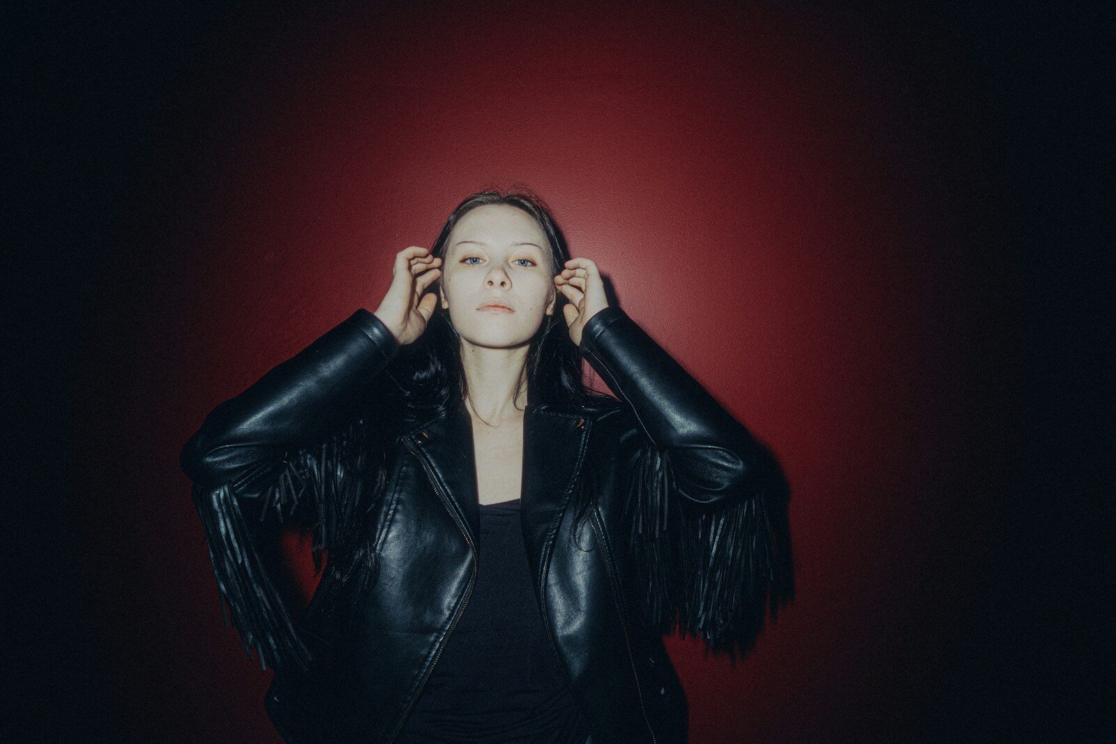 Woman in black leather jacket with fringe detail